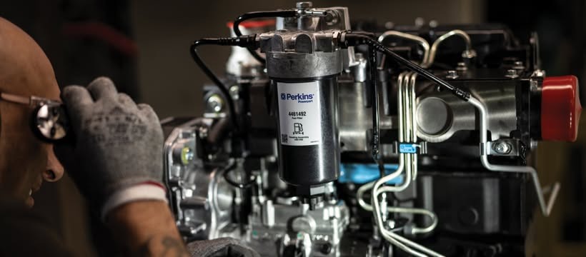 Technician servicing a Perkins diesel engine