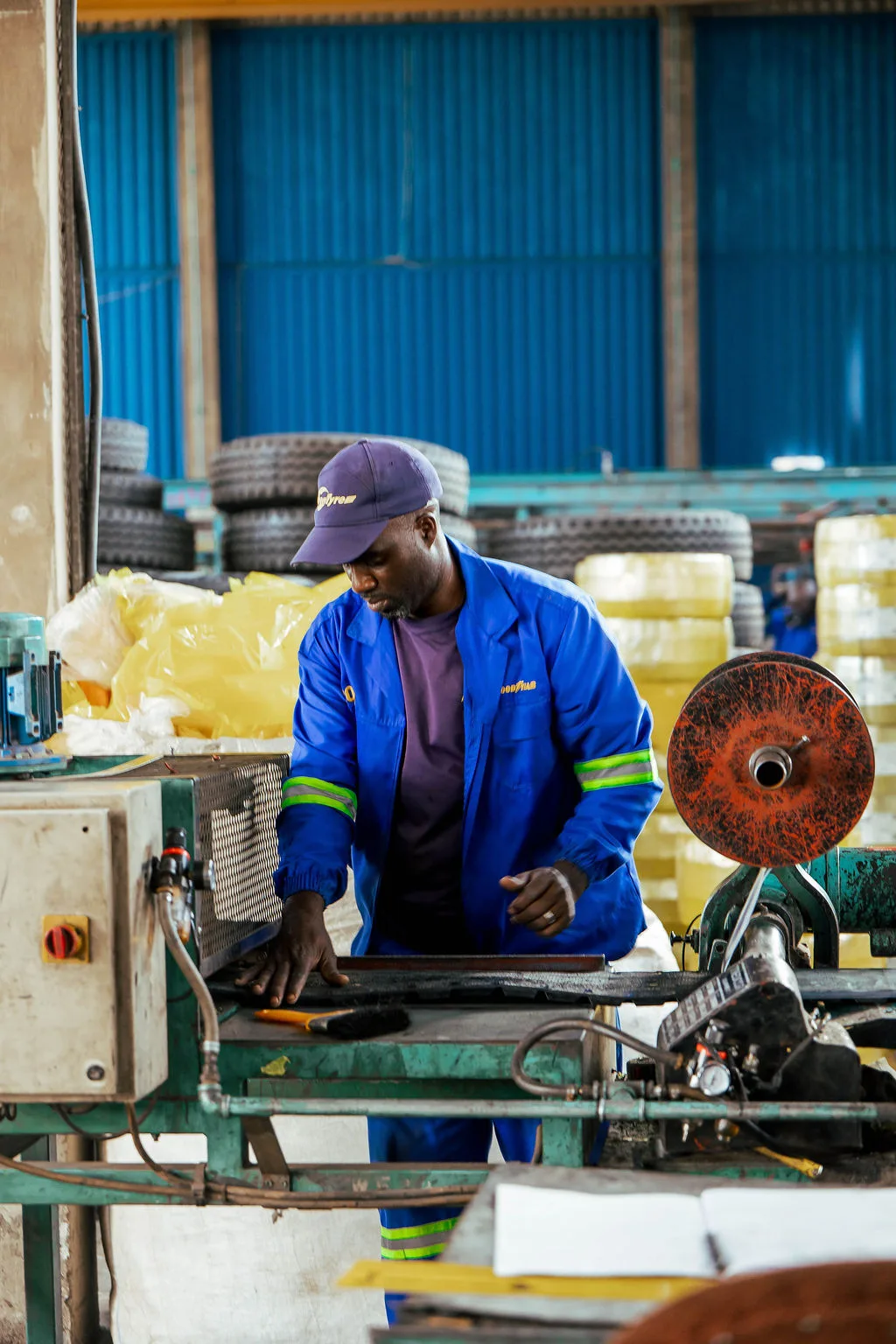 TrenTyre technician operating retreading factory equipment